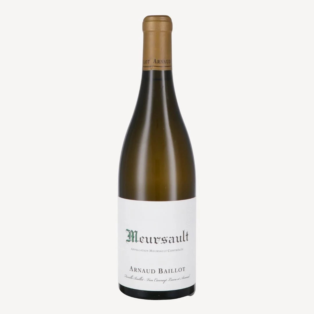 A bottle of Meursault wine by Arnaud Baillot features a clean, white label with elegant green text. The bottle’s dark green glass and golden cap give a classic, refined appearance.