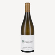 A bottle of Meursault wine by Arnaud Baillot features a clean, white label with elegant green text. The bottle’s dark green glass and golden cap give a classic, refined appearance.